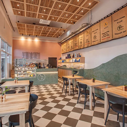 A vibrant coffee shop interior with modern decor and cozy seating, perfect for casual meetups and coffee enthusiasts.