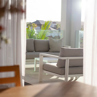 Modern living room with comfortable sofas and bright natural light, perfect for relaxation and socialising.